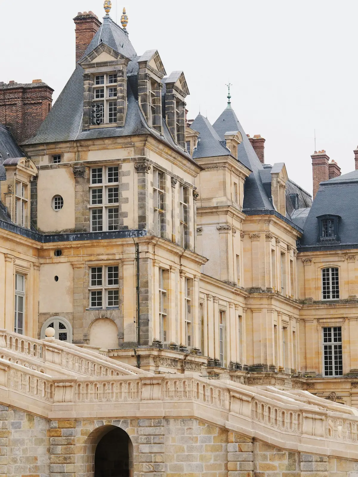 The horseshoe staircase and facade of the Chateau de Fontainebleau