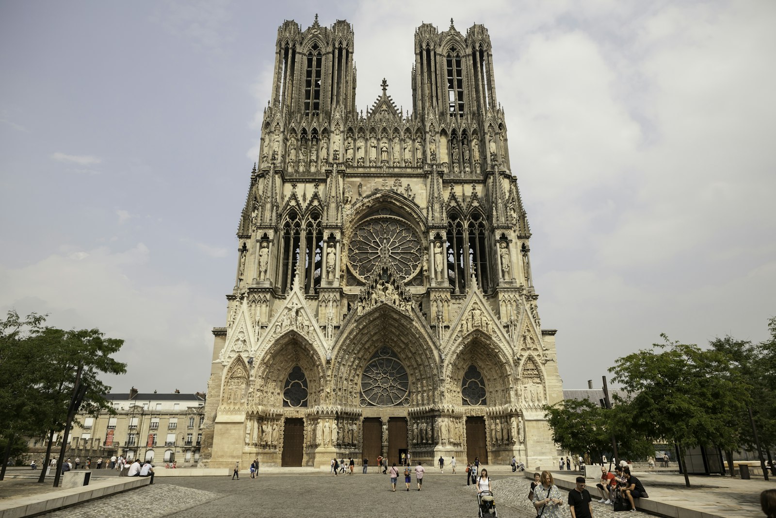 The west front of Reims Cathedral with its twin flat-topped towers and the Gallery of Kings