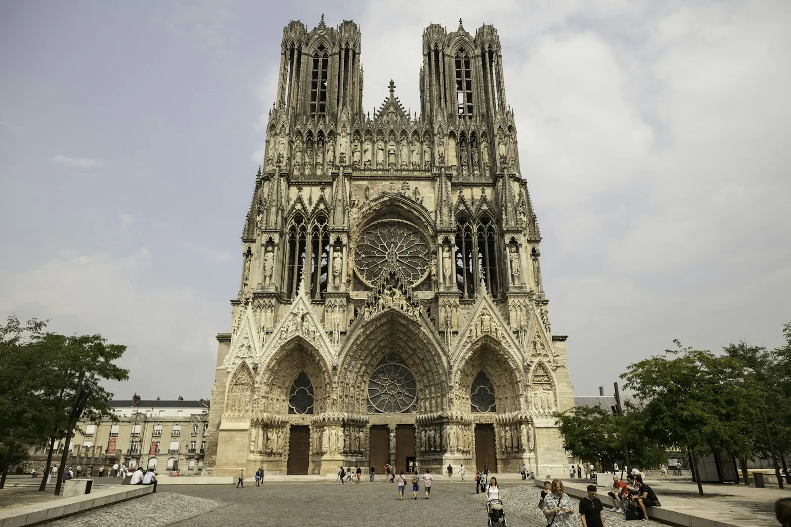 The west front of Reims Cathedral with its twin flat-topped towers and the Gallery of Kings